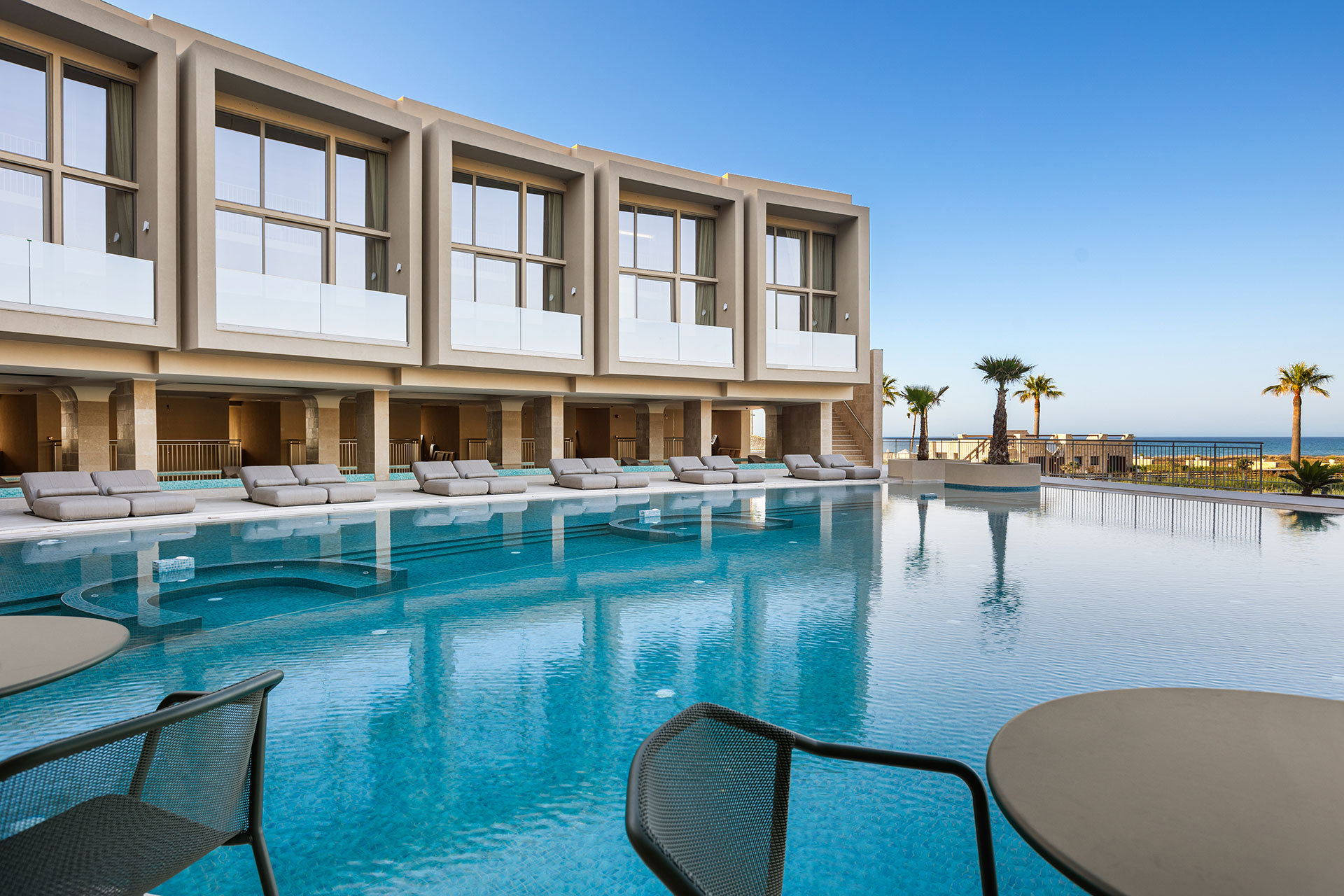 Ventale Island Breeze Resort main pool, sets of sunbeds and the resort